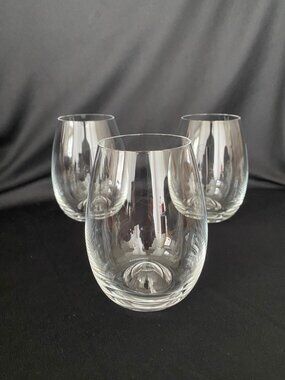 Set of three (3) Dartington crystal stemless wine glasses.